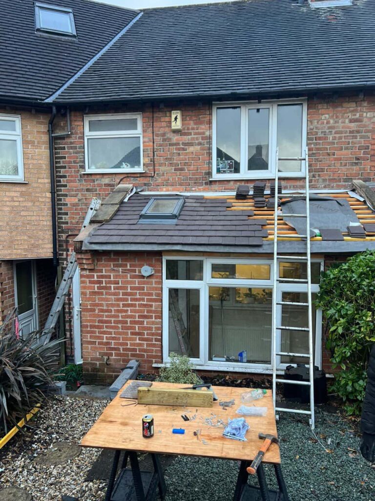 This is a photo of a roof extension that is having new roof tiles installed. This is a photo taken from the roof ridge looking down a tiled pitched roof on to a flat roof. Works carried out by Hillfield This is a photo taken from a roof showing the hip tiles which have been removed and are just about to be repaired Roofing Repairs