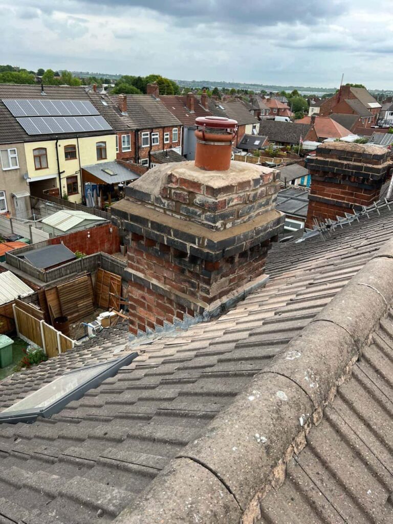 This is a photo taken from a roof which is being repaired by Hillfield This is a photo taken from a roof showing the hip tiles which have been removed and are just about to be repaired Roofing Repairs, it shows a street of houses, and their roofs