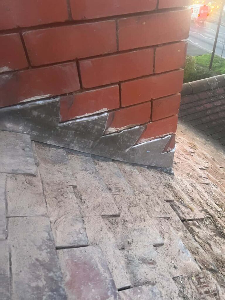 This is a photo of new leadwork being installed around an old chimney. Works carried out by Hillfield Roofing Repairs
